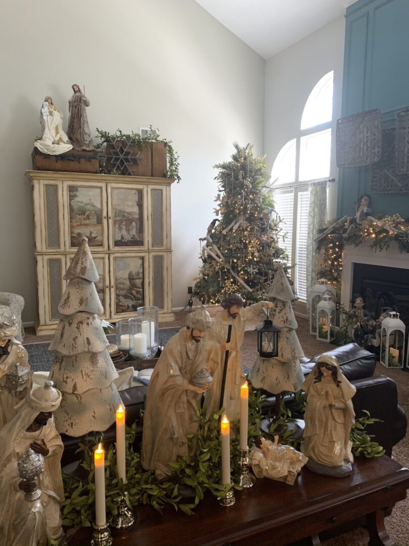 A room filled with nativity scene and candles.